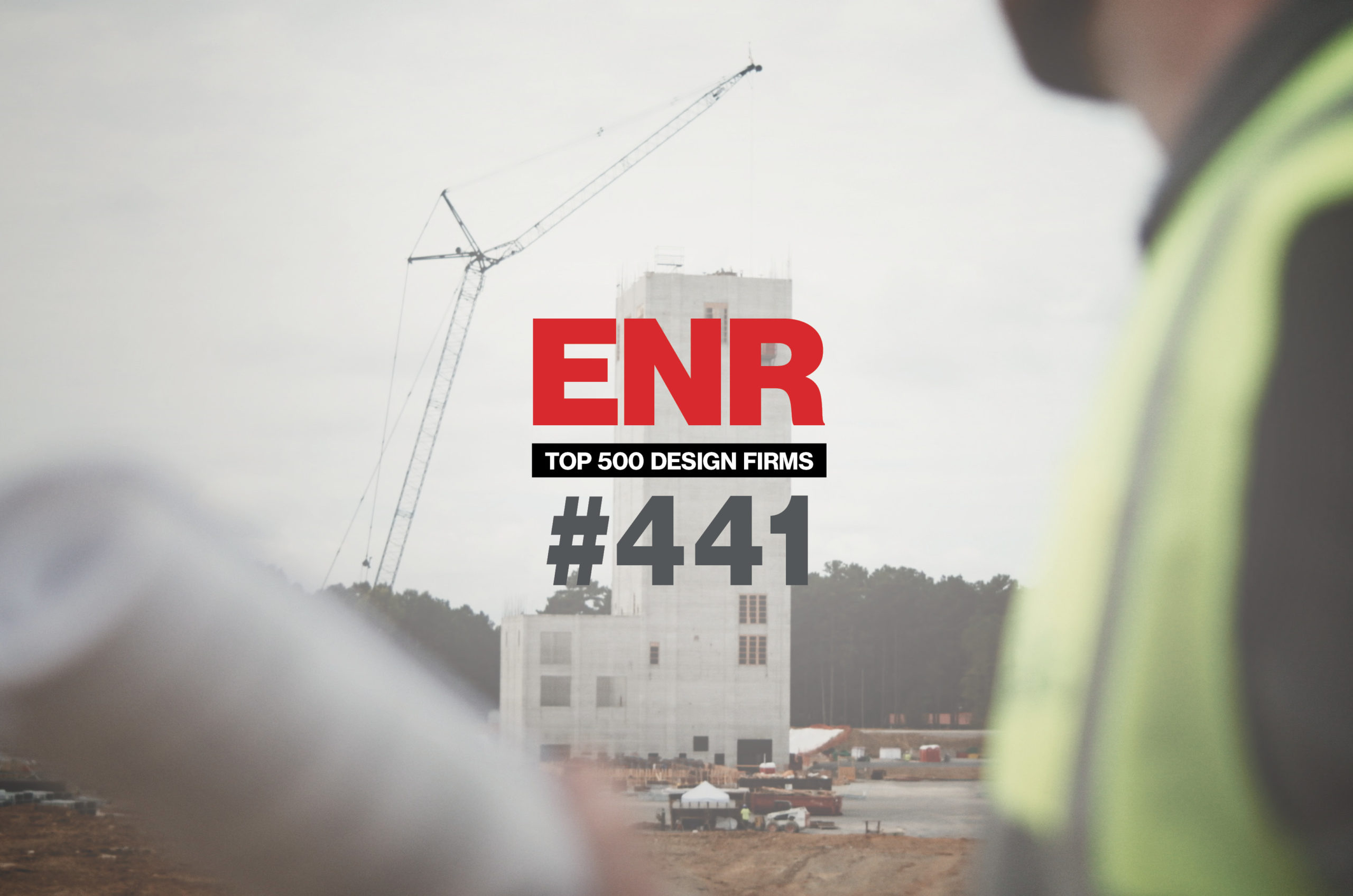 Construction site with ENR ranking and worker.